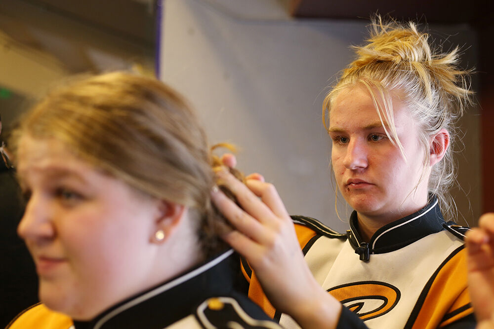 Anna Gross adjusts Olivia Rhoads’ hair as the group starts getting ready